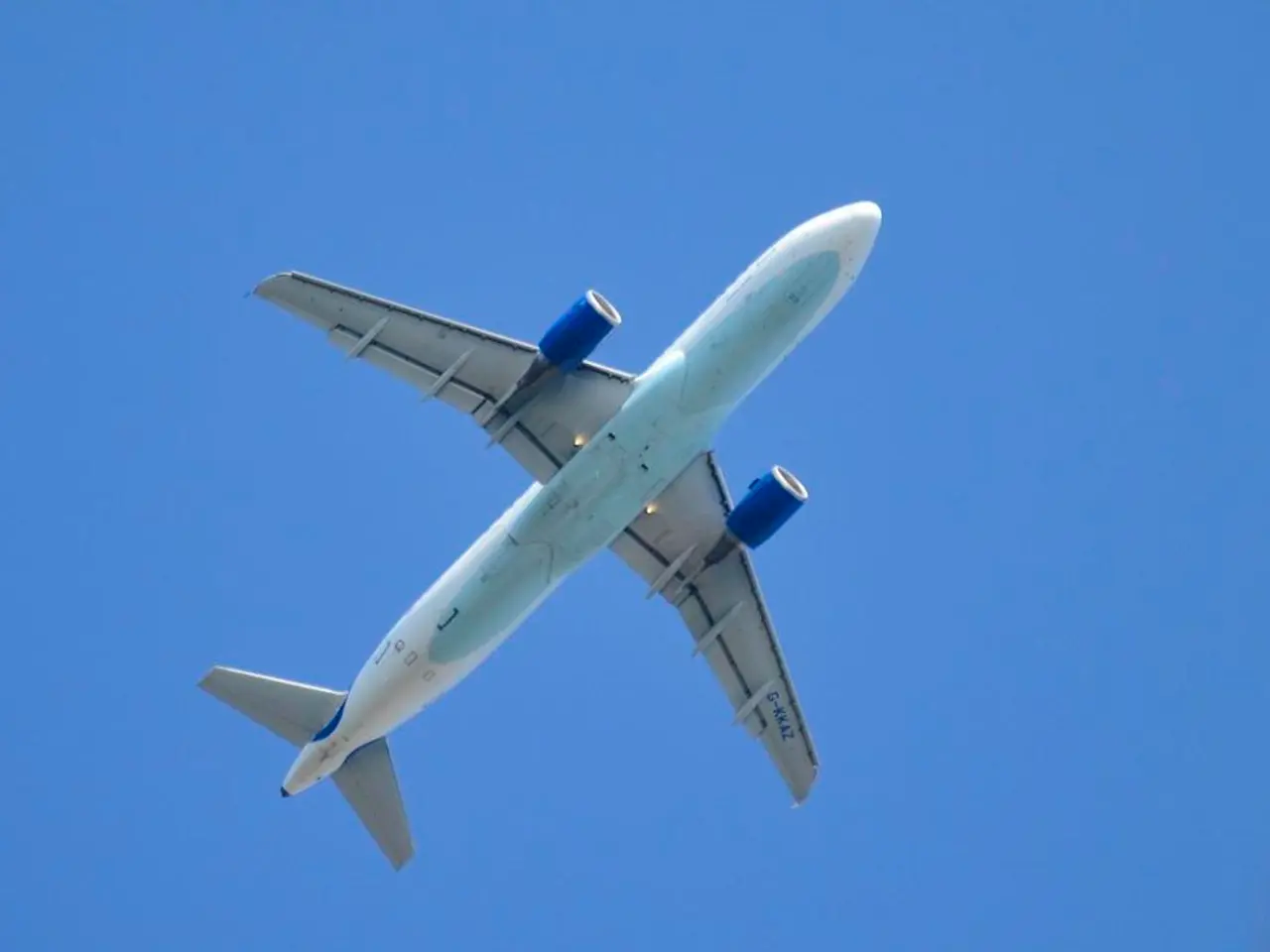 In this image I can see the aircraft flying in the air. It is in white and blue color. Background...