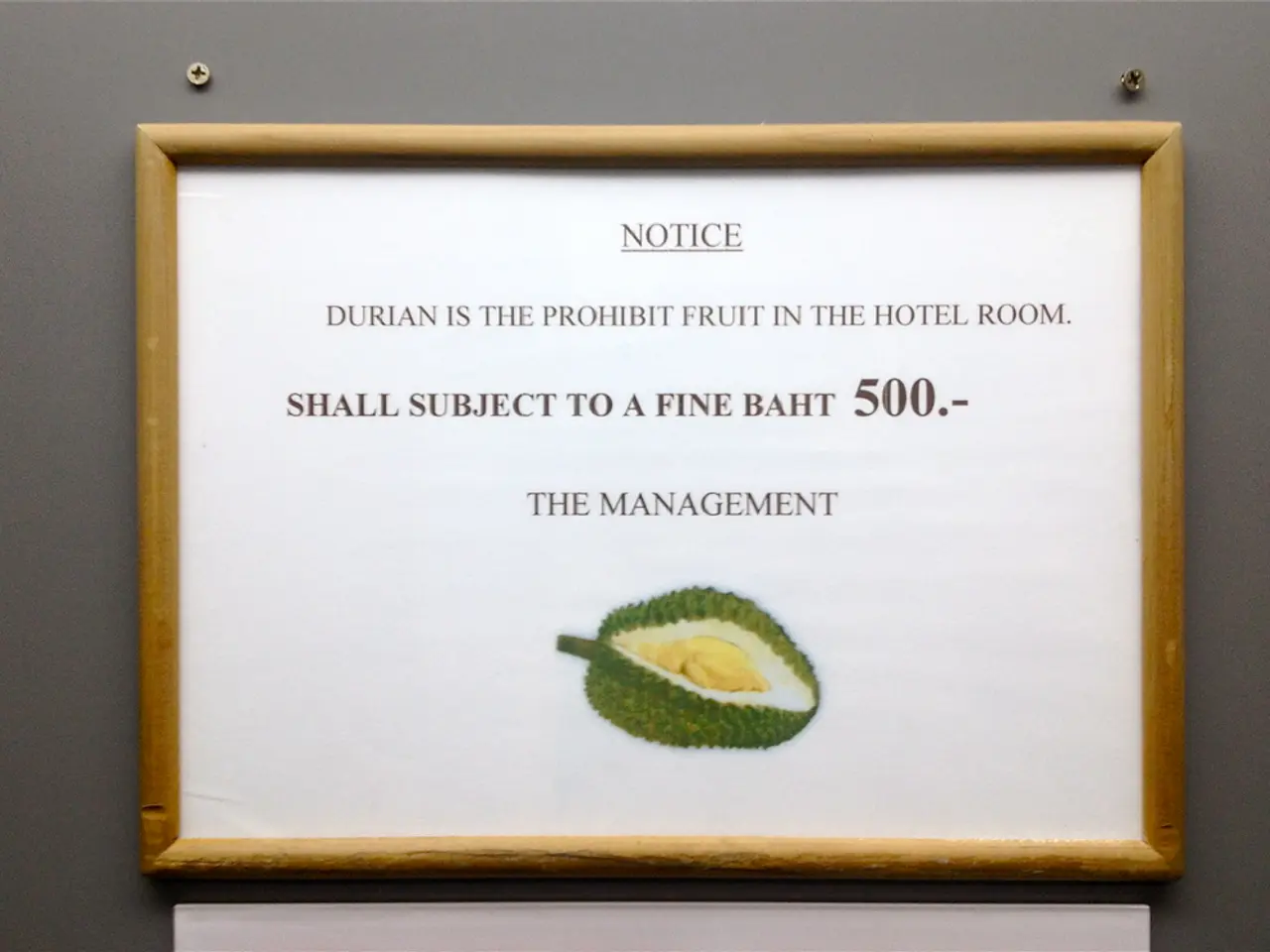 Here we can see a notice board on this gray wall. We can see an information on this notice board....