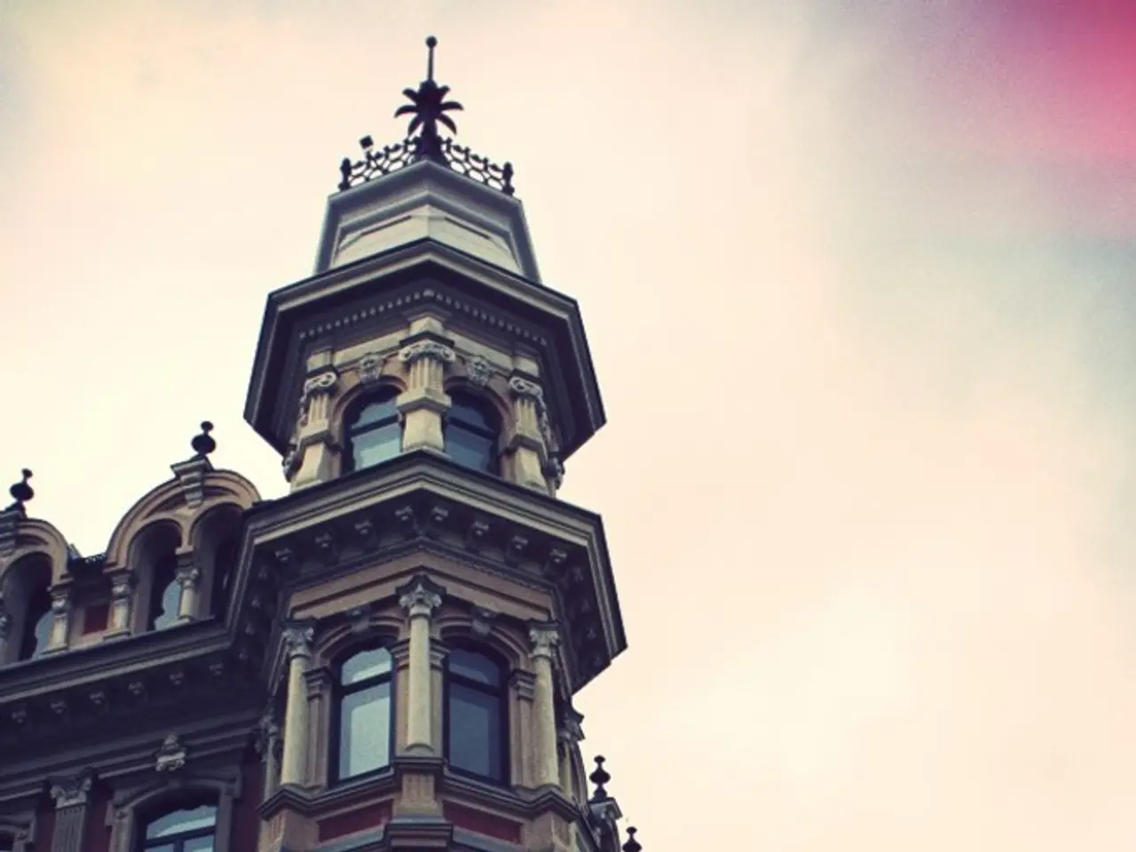 Building with glass windows. Sky is cloudy.