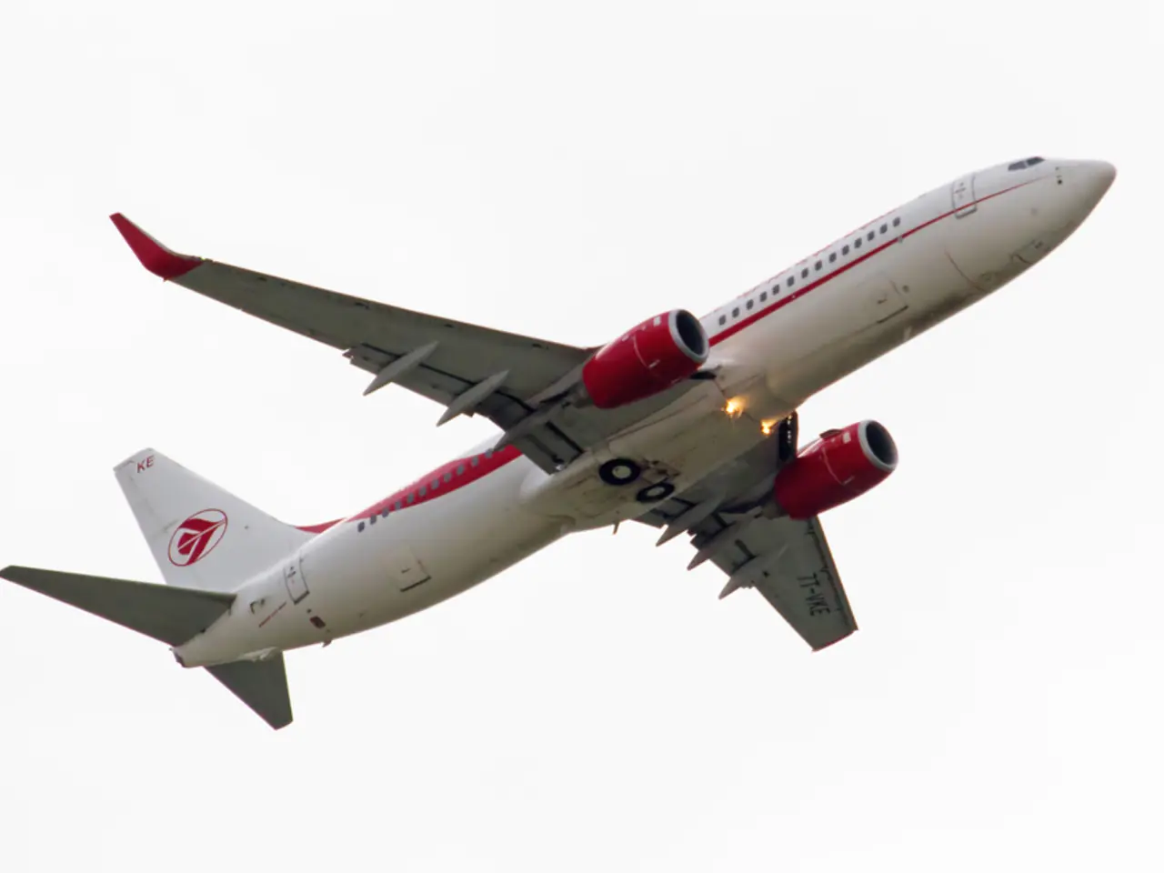 In this image we can see one white aircraft flying in the sky.