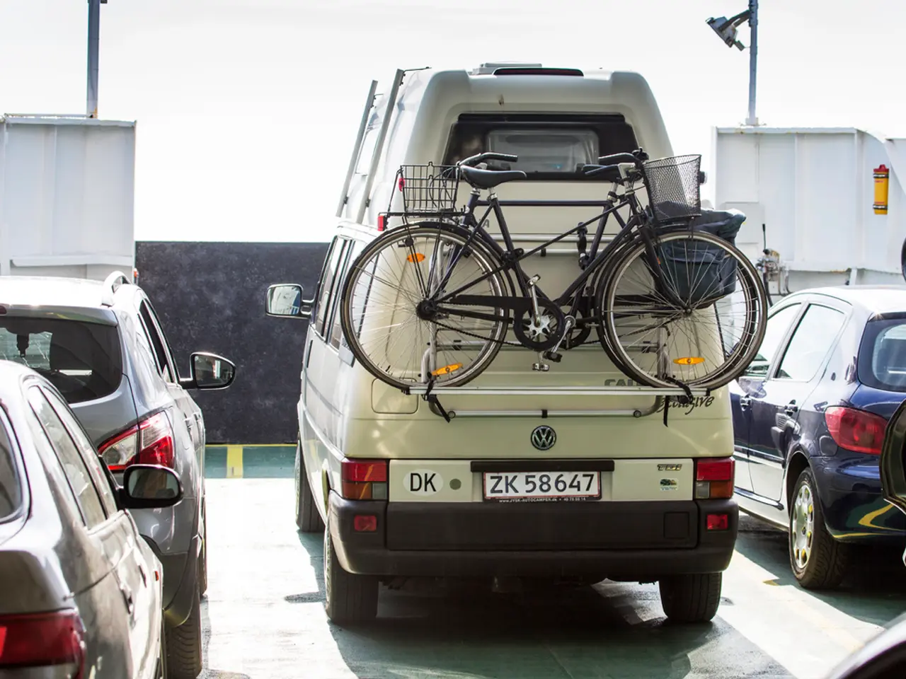 This image consists of some vehicles in the middle. There are cars, bicycles. They are of different...