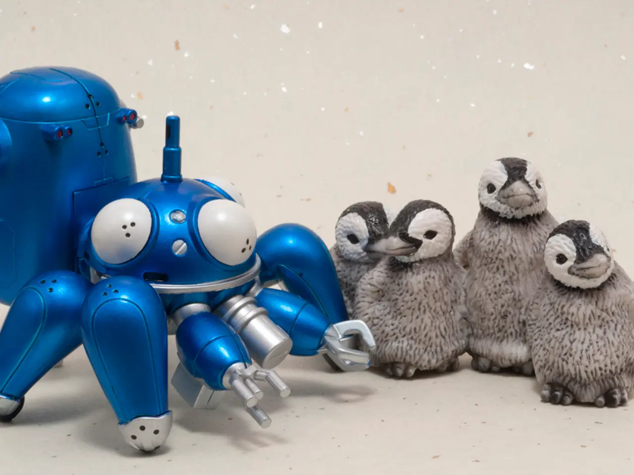 This picture shows a toy and few toy penguins.