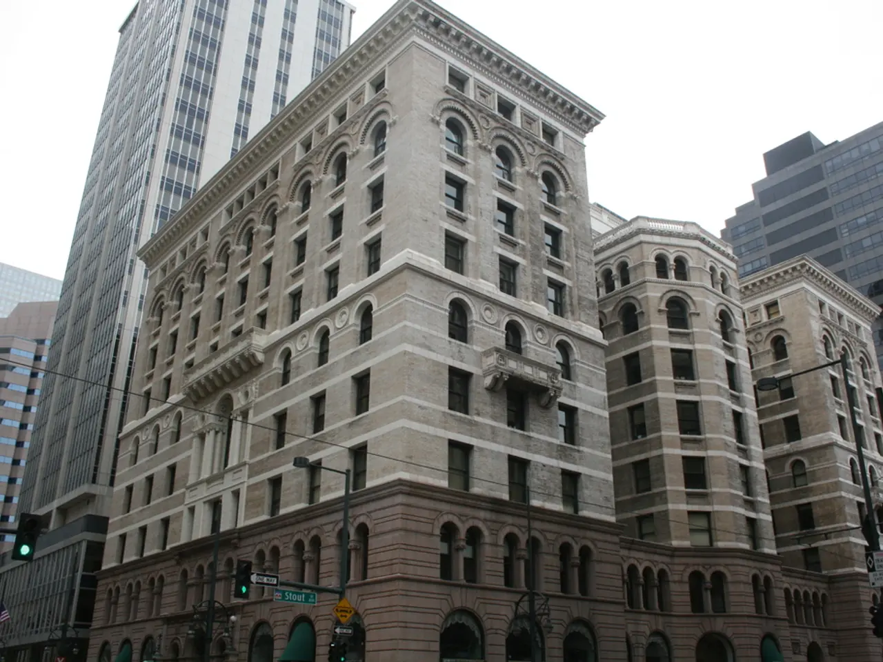 In this picture we can see there are buildings. In front of the buildings, there are poles with...