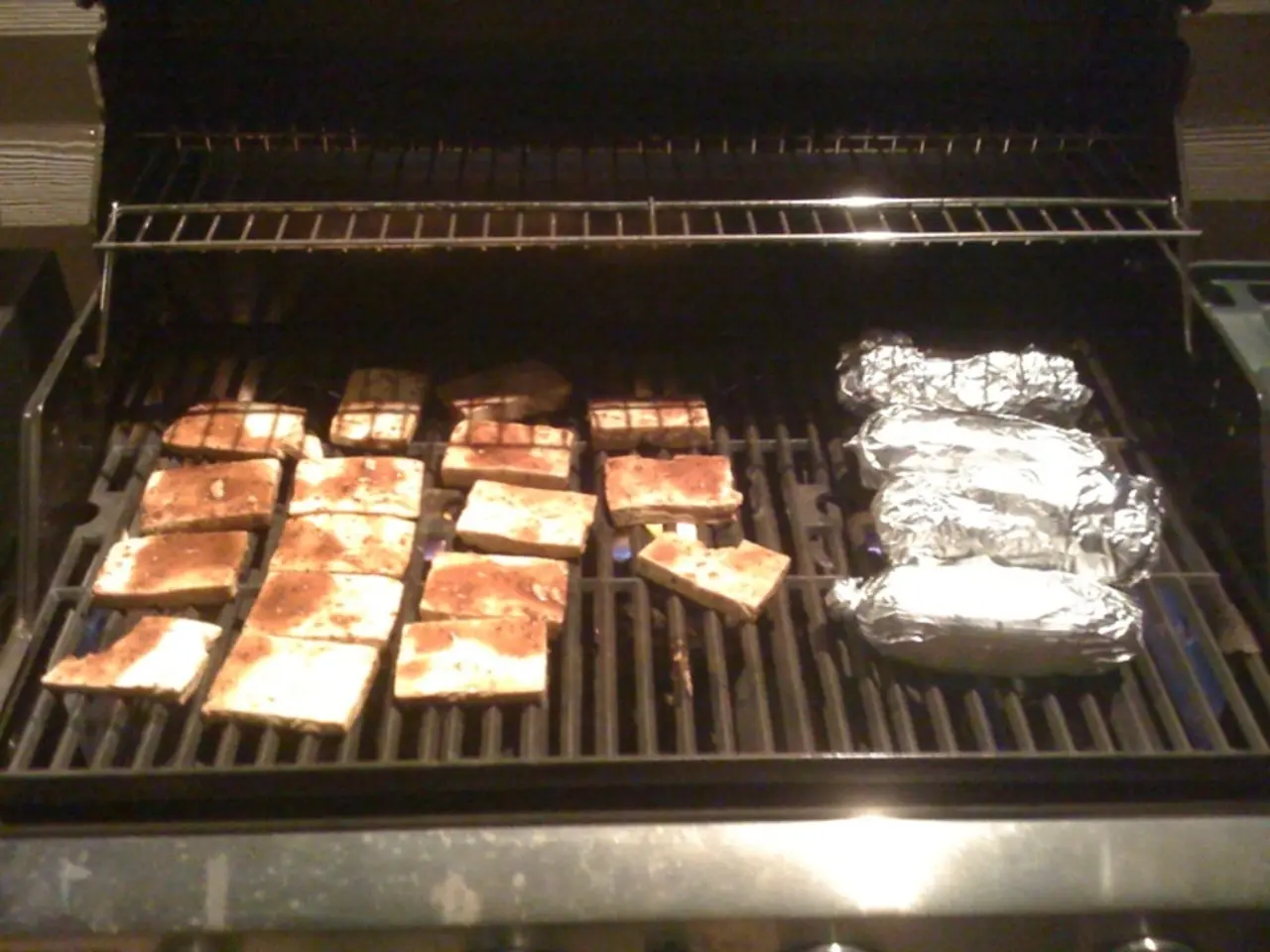 In the image I can see a grill on which there is some food item and also I can see some other food...