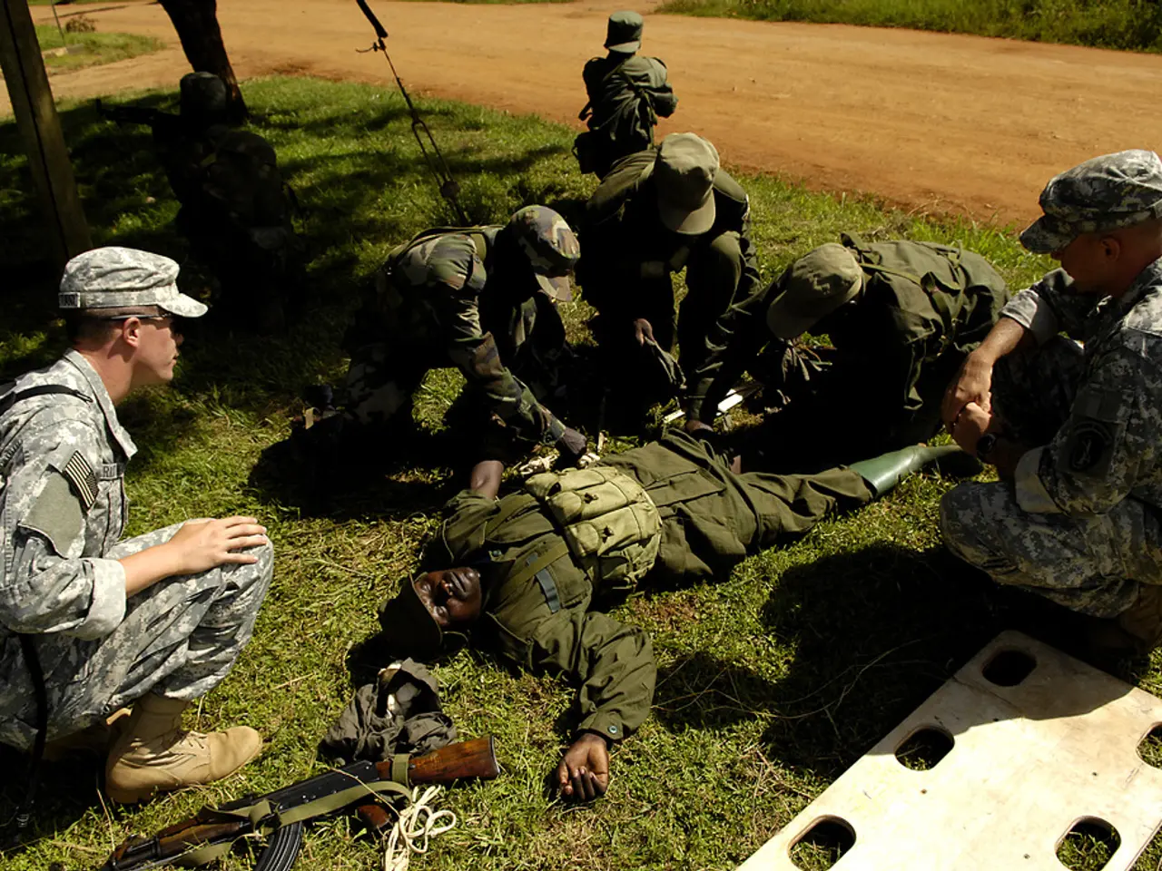 This image consists of few persons. They are wearing the army dresses. At the bottom, there is...