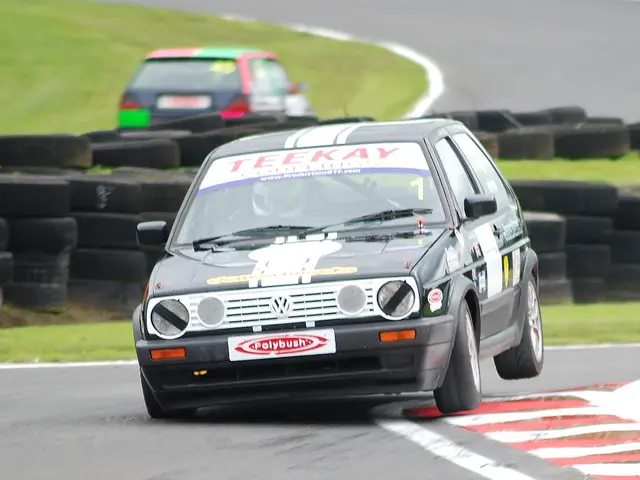 In this image, we can see some tires. There are cars in the middle of the image.