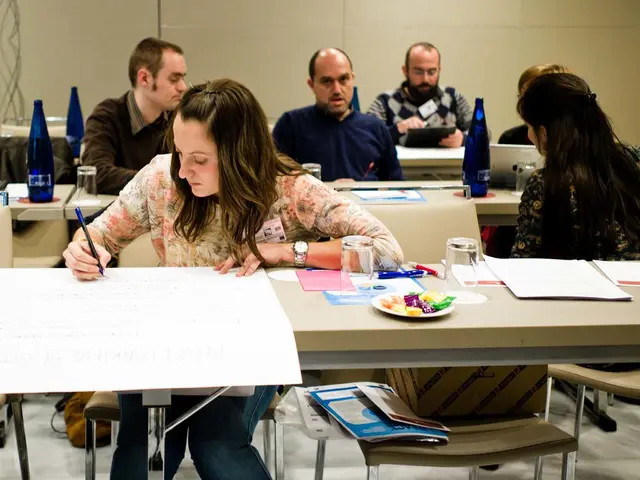 This image is taken in a classroom. The classroom is filled with the tables and chairs. There are 6...