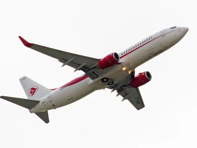 In this image we can see one white aircraft flying in the sky.