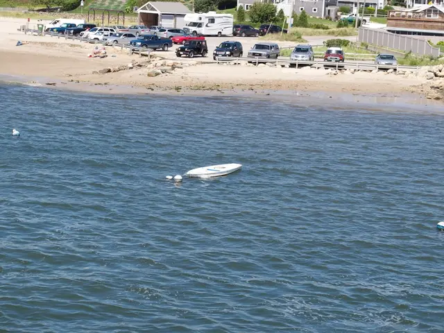 In this image sea is there and on the surface of sea boat is present. Background of the image cars...