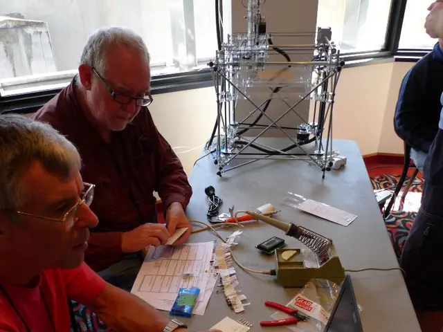 here in this picture we can see two persons sitting on the chair and doing some work in the laptop...