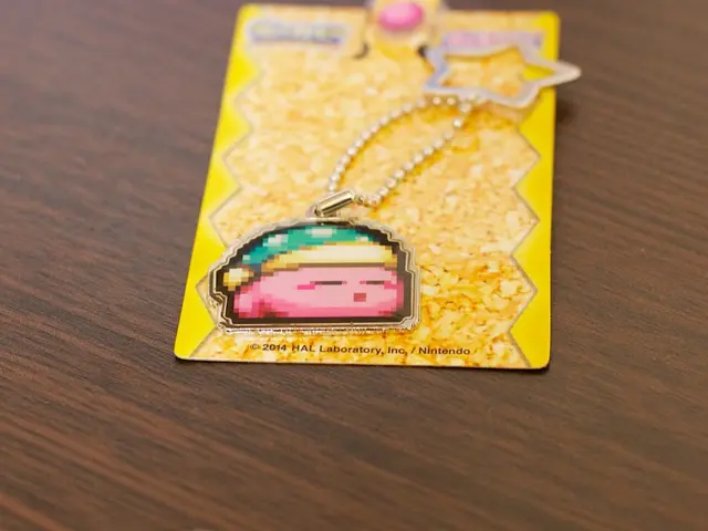 In this image there is a car key chain on the table. The keychain is packed in the cover.