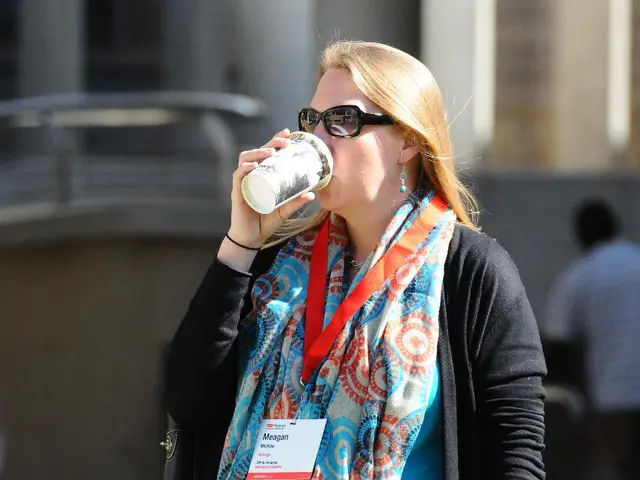 In the image here is a woman she is drinking some drink, she is wearing goggles and there is an...
