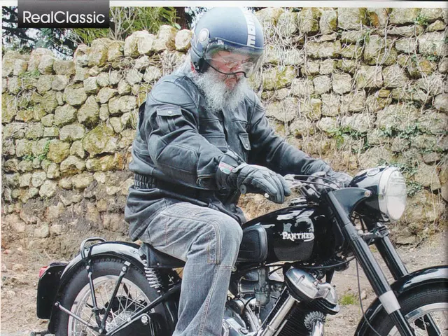 In this picture we can see man riding bike wore helmet and in background we can see stones wall and...