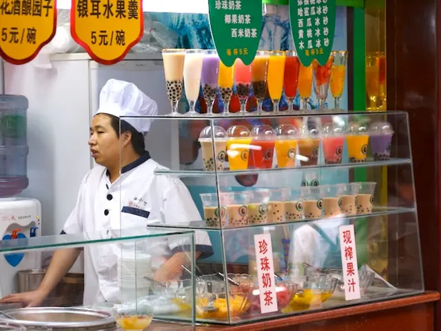 In the image we can see there is a chef standing and there are juice glasses kept on the table....